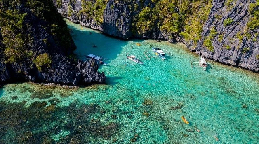 Aerial view of boats and kayaks in the clear water of the Big Lagoon